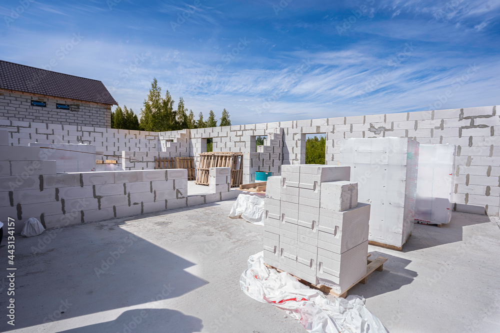 house construction. raising the walls with aerated concrete blocks, several pallets of bricks. Hight thermal conductivity
